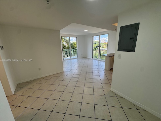 3500 Coral Way Unit 501, Miami, FL 33145 - spare room featuring electric panel, light tile patterned floors, and baseboards