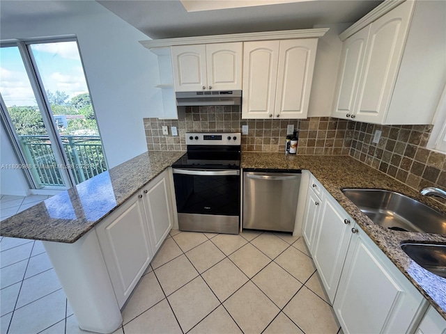 3500 Coral Way Unit 501, Miami, FL 33145 - kitchen featuring stainless steel appliances, a peninsula, under cabinet range hood, white cabinets, and light tile patterned flooring
