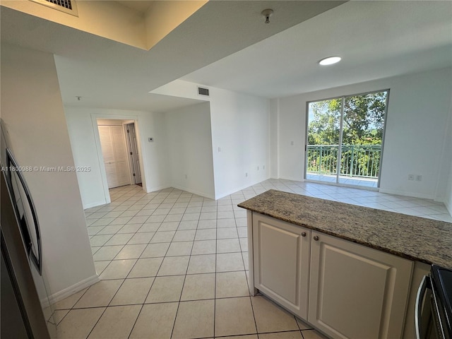 3500 Coral Way Unit 501, Miami, FL 33145 - kitchen featuring range, light tile patterned flooring, and baseboards