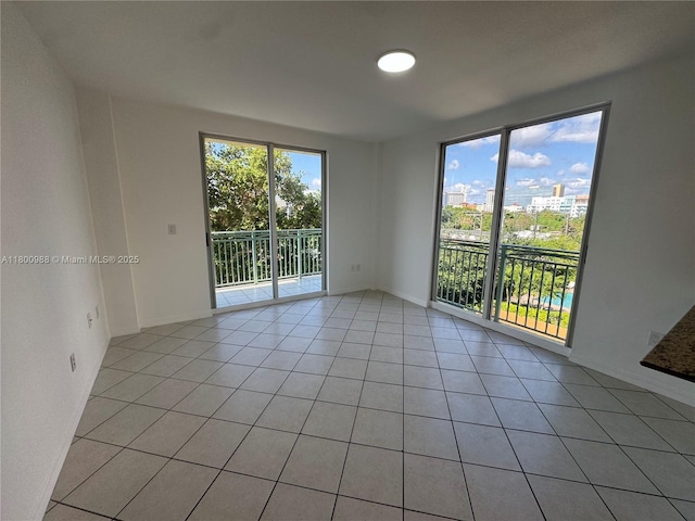 3500 Coral Way Unit 501, Miami, FL 33145 - unfurnished room featuring plenty of natural light, light tile patterned floors, and baseboards