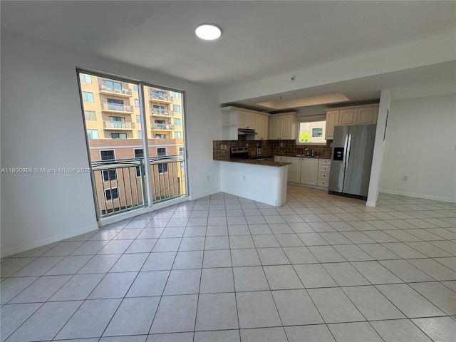 3500 Coral Way Unit 501, Miami, FL 33145 - kitchen with stainless steel appliances, dark countertops, tasteful backsplash, a peninsula, and light tile patterned floors