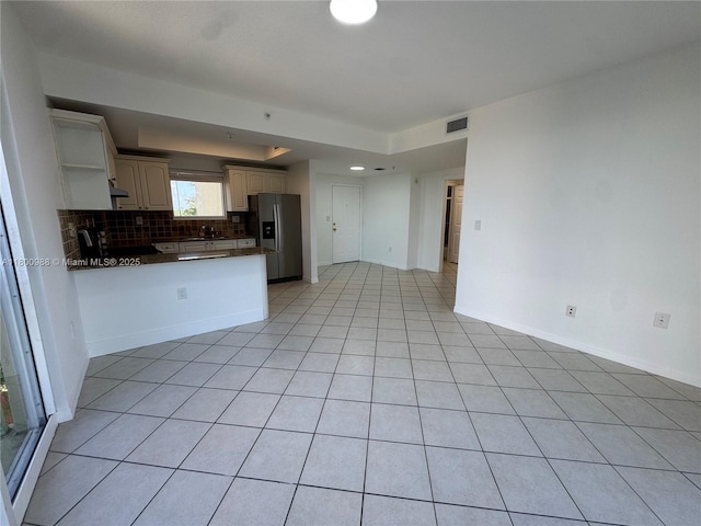 3500 Coral Way Unit 501, Miami, FL 33145 - kitchen featuring stainless steel refrigerator with ice dispenser, dark countertops, a peninsula, tasteful backsplash, and open shelves