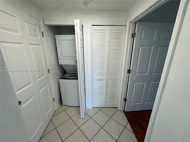 3500 Coral Way Unit 501, Miami, FL 33145 - washroom with stacked washer / dryer and light tile patterned flooring