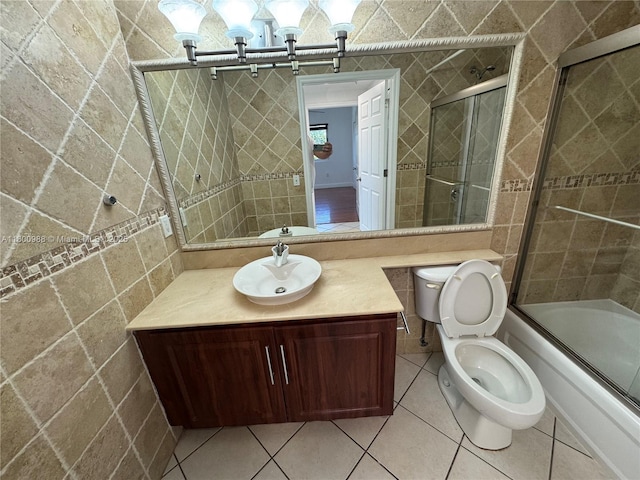 3500 Coral Way Unit 501, Miami, FL 33145 - bathroom featuring tile walls, tile patterned floors, enclosed tub / shower combo, vanity, and toilet