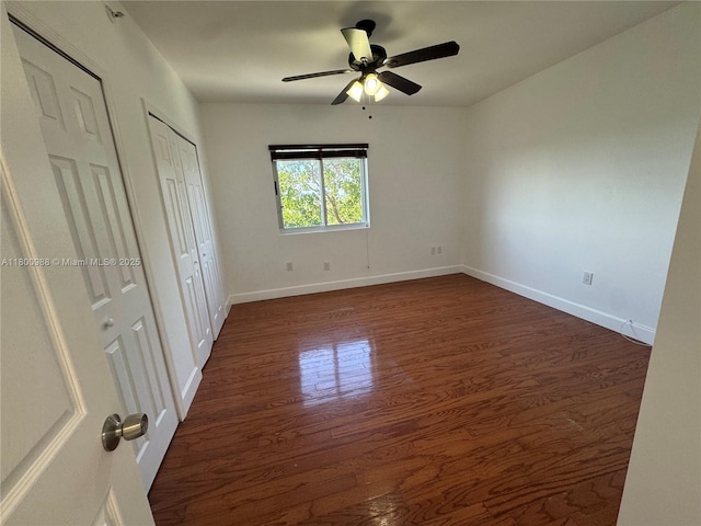 3500 Coral Way Unit 501, Miami, FL 33145 - unfurnished bedroom featuring dark wood finished floors, two closets, baseboards, and a ceiling fan