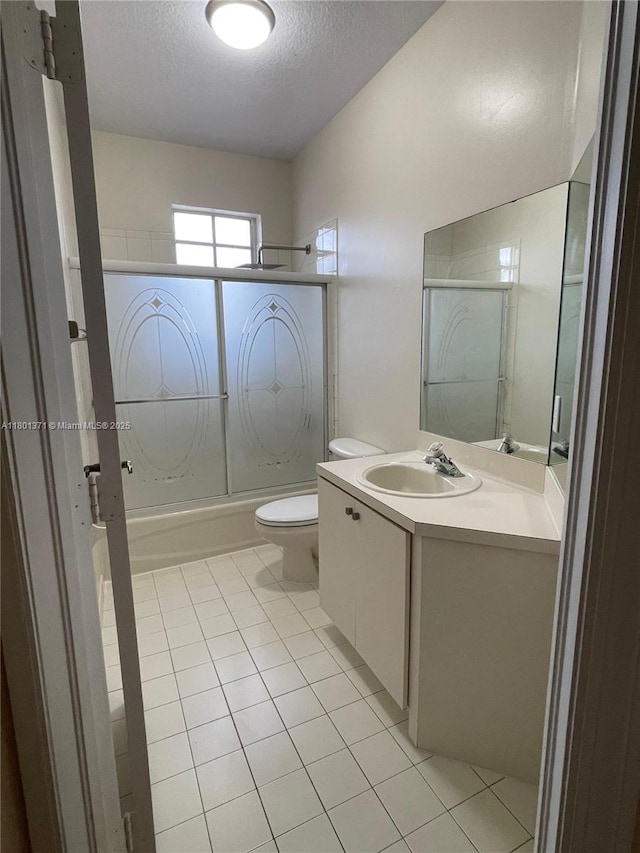12708 SW 49th Dr, Miramar, FL 33027 - full bath with shower / bath combination with glass door, toilet, vanity, a textured ceiling, and tile patterned floors