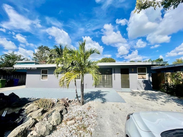 1649 NE 8th Ave, Fort Lauderdale, FL 33305 - view of front facade featuring stucco siding and central AC