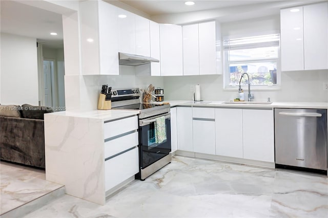 1649 NE 8th Ave, Fort Lauderdale, FL 33305 - kitchen featuring stainless steel appliances, a sink, modern cabinets, recessed lighting, and white cabinets