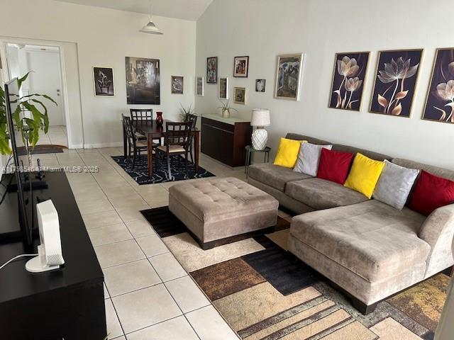 4632 NW 97th Pl Unit 262, Doral, FL 33178 - tiled living room with vaulted ceiling