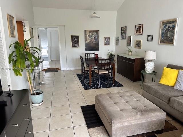 4632 NW 97th Pl Unit 262, Doral, FL 33178 - living area with vaulted ceiling, light tile patterned floors, and baseboards