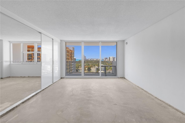 2030 S Ocean Dr Unit 1708, Hallandale Beach, FL 33009 - empty room with a textured ceiling, concrete flooring, a city view, and floor to ceiling windows