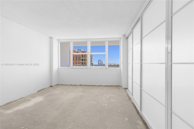 2030 S Ocean Dr Unit 1708, Hallandale Beach, FL 33009 - unfurnished bedroom featuring a textured ceiling and concrete flooring