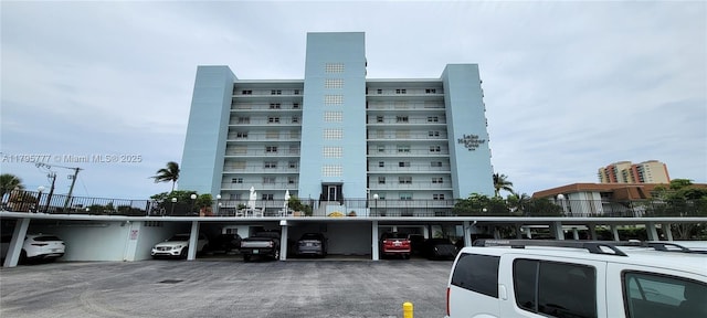3040 Lake Shore Dr, Riviera Beach, FL 33404 - view of apartment building / complex featuring covered parking