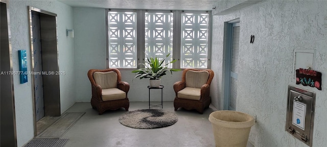3040 Lake Shore Dr, Riviera Beach, FL 33404 - sitting room with concrete floors and a textured wall