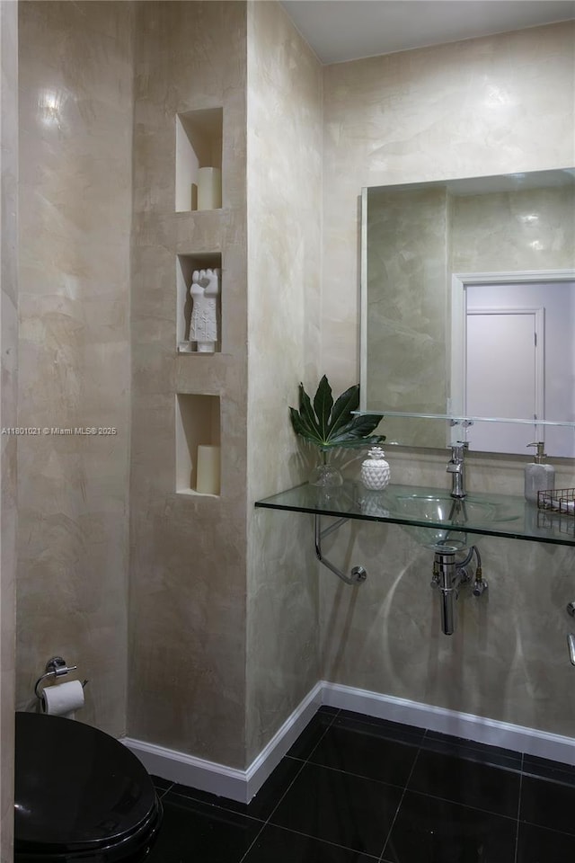 1530 NE Quayside Ter Unit A1, Miami, FL 33138 - bathroom featuring tile patterned flooring, toilet, a sink, and baseboards