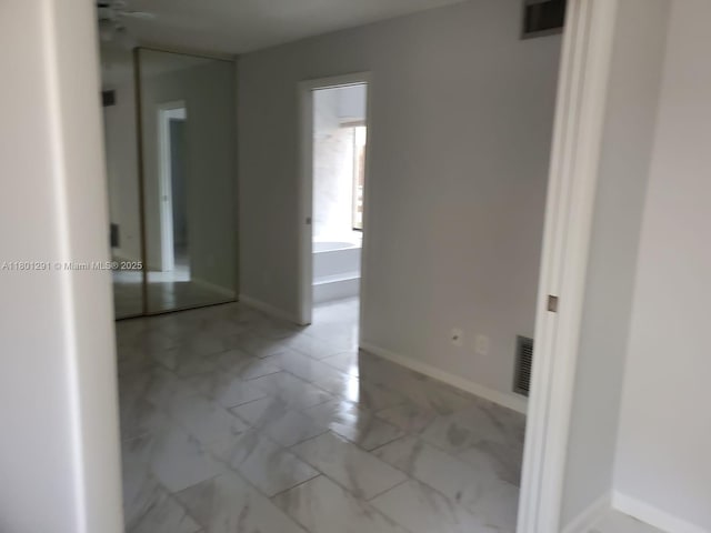 637 Executive Center Dr Unit N102, West Palm Beach, FL 33401 - hallway featuring light marble finish floors and baseboards