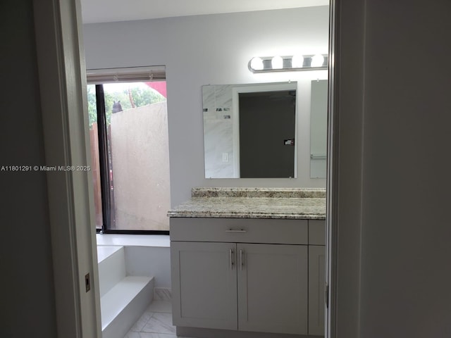 637 Executive Center Dr Unit N102, West Palm Beach, FL 33401 - bathroom with marble look tiles and vanity