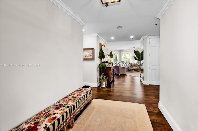 hall featuring crown molding, dark wood finished floors, baseboards, and recessed lighting