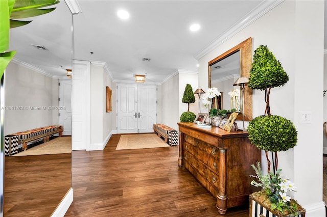 entrance foyer featuring wood finished floors, recessed lighting, crown molding, and baseboards