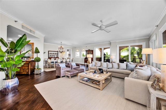 living area featuring plenty of natural light, ceiling fan, wood finished floors, crown molding, and a chandelier