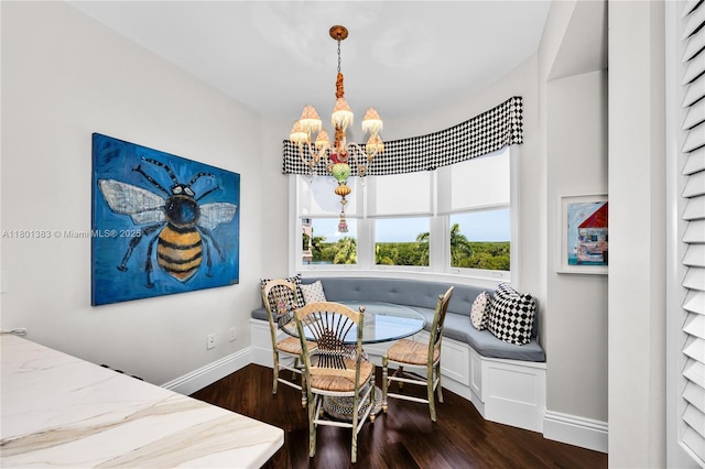 dining area with breakfast area, a chandelier, baseboards, and wood finished floors