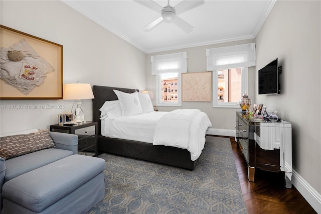 bedroom featuring ornamental molding, wood finished floors, baseboards, and ceiling fan