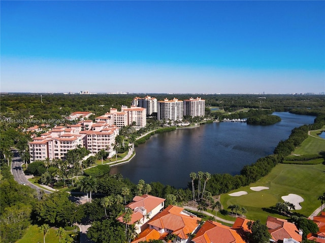 aerial overview of property's location with a large body of water, a golf club, and apartment complex / building