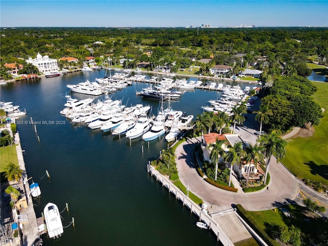 drone / aerial view of a nearby body of water and a marina