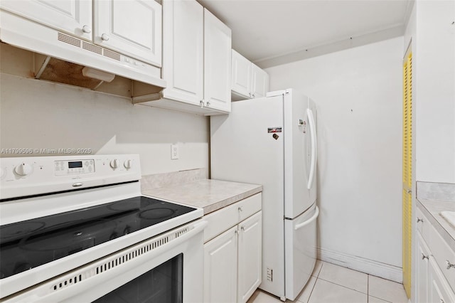 kitchen featuring white appliances, under cabinet range hood, light countertops, white cabinets, and light tile patterned flooring