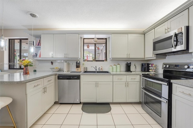 735 SW 158th Ter, Sunrise, FL 33326 - kitchen with stainless steel appliances, a sink, a peninsula, open shelves, and decorative backsplash