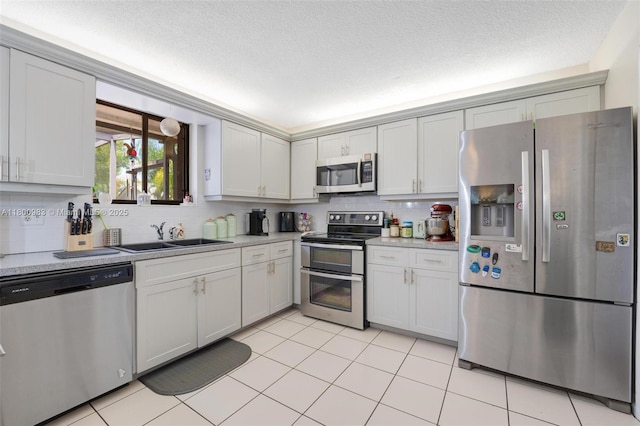 735 SW 158th Ter, Sunrise, FL 33326 - kitchen featuring appliances with stainless steel finishes, a sink, light countertops, backsplash, and a textured ceiling