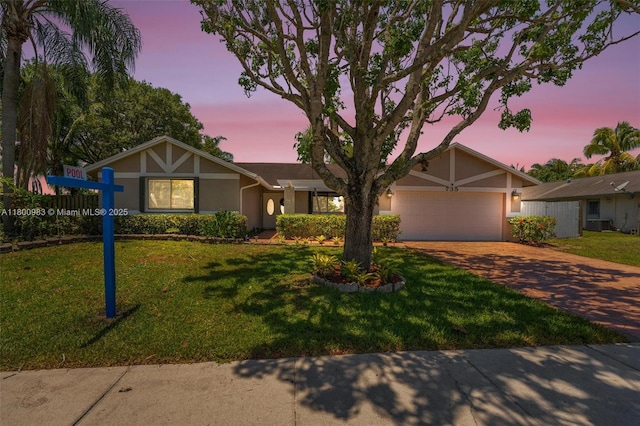 735 SW 158th Ter, Sunrise, FL 33326 - view of front of home featuring stucco siding, decorative driveway, an attached garage, and a front lawn