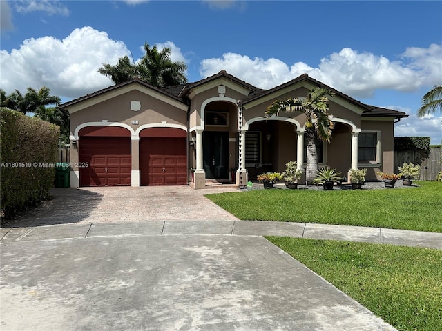 8216 SW 166th Pl, Miami, FL 33193 - mediterranean / spanish house with stucco siding, an attached garage, driveway, and a front yard