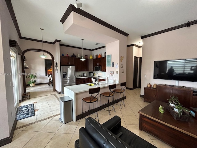 8216 SW 166th Pl, Miami, FL 33193 - kitchen with stainless steel appliances, light tile patterned floors, open floor plan, and crown molding