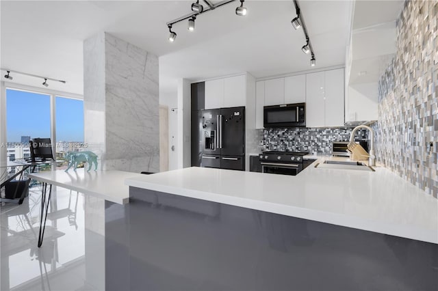2030 S Ocean Dr Unit 1707, Hallandale Beach, FL 33009 - kitchen featuring track lighting, high quality appliances, a sink, a peninsula, and light countertops