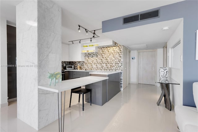 2030 S Ocean Dr Unit 1707, Hallandale Beach, FL 33009 - kitchen with modern cabinets, decorative backsplash, light countertops, and light tile patterned flooring