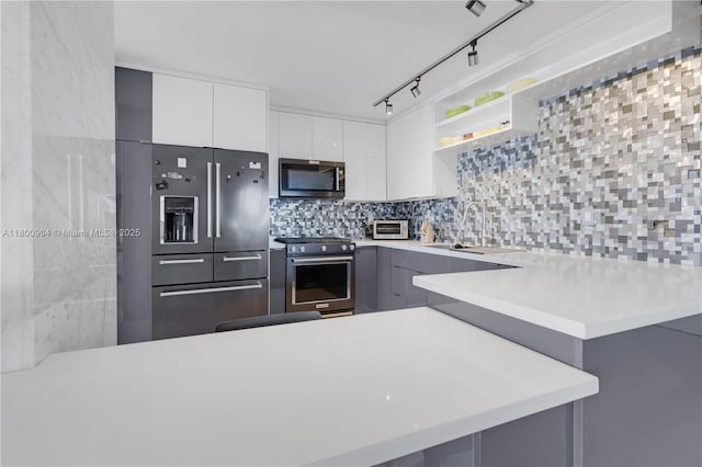 2030 S Ocean Dr Unit 1707, Hallandale Beach, FL 33009 - kitchen featuring stainless steel appliances, a sink, open shelves, light countertops, and modern cabinets