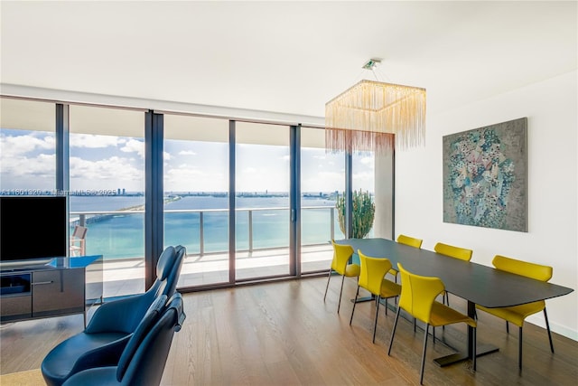 3131 NE 7th Ave Unit 3606, Miami, FL 33137 - dining space with wood finished floors, a water view, and a wall of windows
