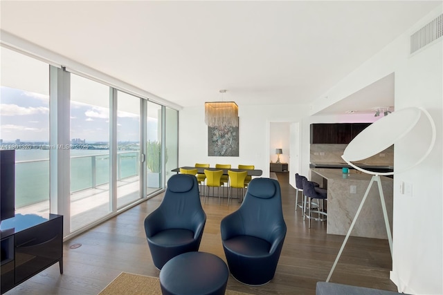 3131 NE 7th Ave Unit 3606, Miami, FL 33137 - living room with a wall of windows, wood finished floors, and a water view