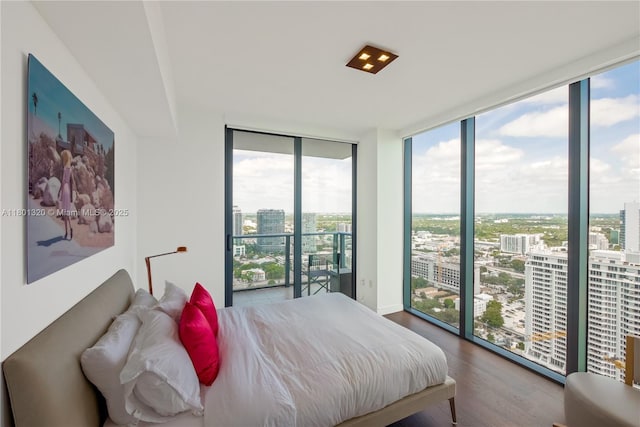 3131 NE 7th Ave Unit 3606, Miami, FL 33137 - bedroom featuring floor to ceiling windows, a city view, and wood finished floors
