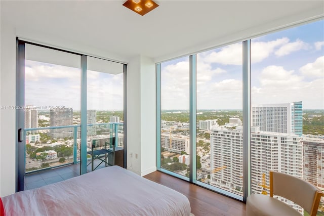 3131 NE 7th Ave Unit 3606, Miami, FL 33137 - bedroom featuring floor to ceiling windows, a city view, and wood finished floors