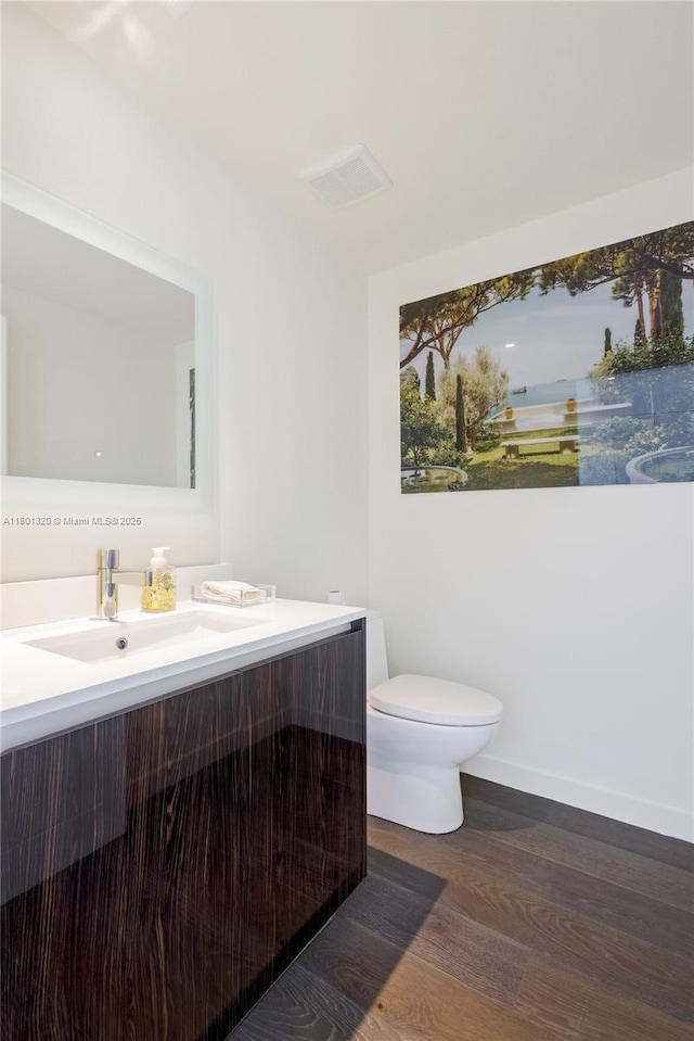 3131 NE 7th Ave Unit 3606, Miami, FL 33137 - half bath featuring wood finished floors, vanity, and toilet