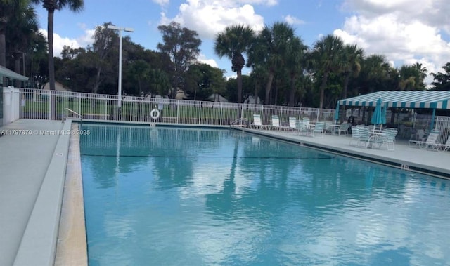 3664 Alder Dr Unit B1, West Palm Beach, FL 33417 - community pool featuring fence, a patio, and view of scattered trees