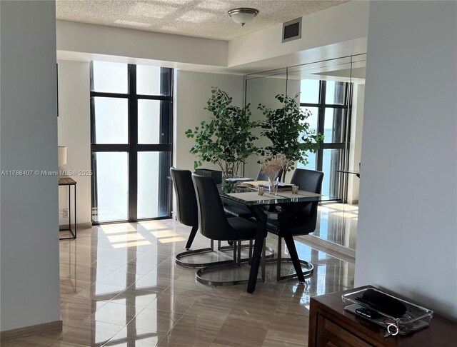 4000 NE Towwerside Ter Unit 1101, Miami, FL 33138 - dining space featuring a textured ceiling