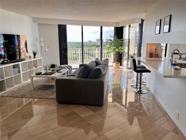 4000 NE Towwerside Ter Unit 1101, Miami, FL 33138 - living area featuring expansive windows and a textured ceiling