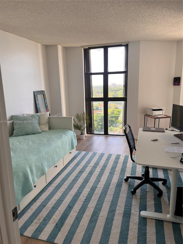 4000 NE Towwerside Ter Unit 1101, Miami, FL 33138 - bedroom with a textured ceiling, an office area, and wood finished floors