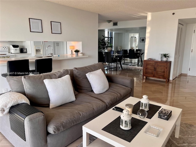 4000 NE Towwerside Ter Unit 1101, Miami, FL 33138 - living area featuring a textured ceiling