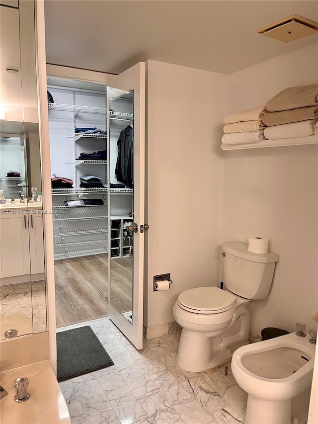 4000 NE Towwerside Ter Unit 1101, Miami, FL 33138 - full bathroom with marble look tile flooring, toilet, a bidet, and vanity