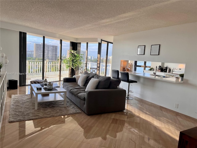 4000 NE Towwerside Ter Unit 1101, Miami, FL 33138 - living area featuring a city view, a wall of windows, and a textured ceiling
