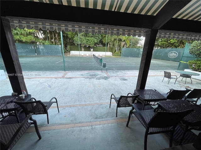 4000 NE Towwerside Ter Unit 1101, Miami, FL 33138 - view of patio / terrace with a tennis court and fence